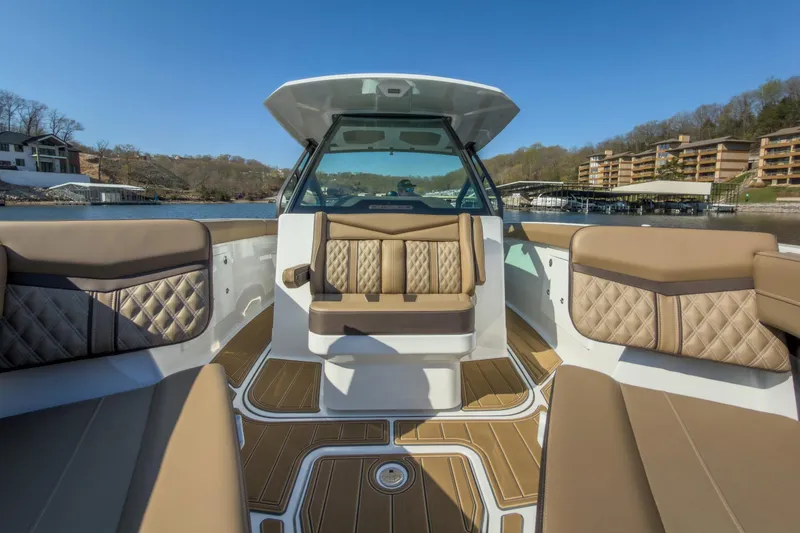 Slide: The Image of Luxurious interior of 2026 Monterey Elite 30 OB boat with elegant seating and scenic view. - 17