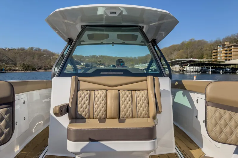 Slide: The Image of 2026 Monterey Elite 30 OB boat interior with luxurious seating and scenic lake view. - 18