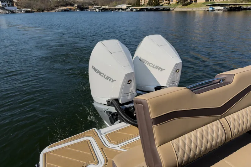 Slide: The Image of 2026 Monterey Elite 30 OB boat with dual Mercury outboard engines on a lake. - 23