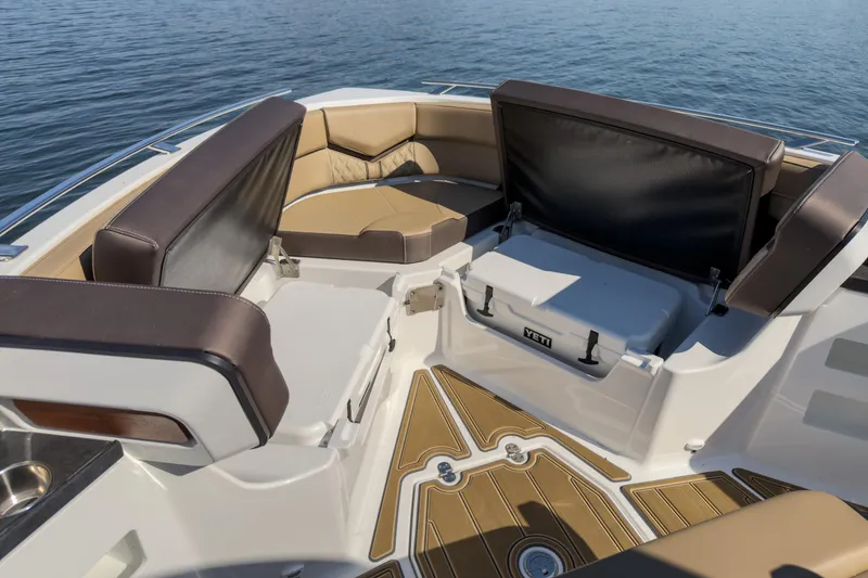 Slide: The Image of Luxurious seating area on 2026 Monterey Elite 30 OB boat with storage and cooler. - 26