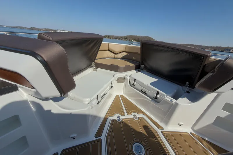 Slide: The Image of Luxurious seating area on 2026 Monterey Elite 30 OB boat, featuring stylish cushions and storage. - 27
