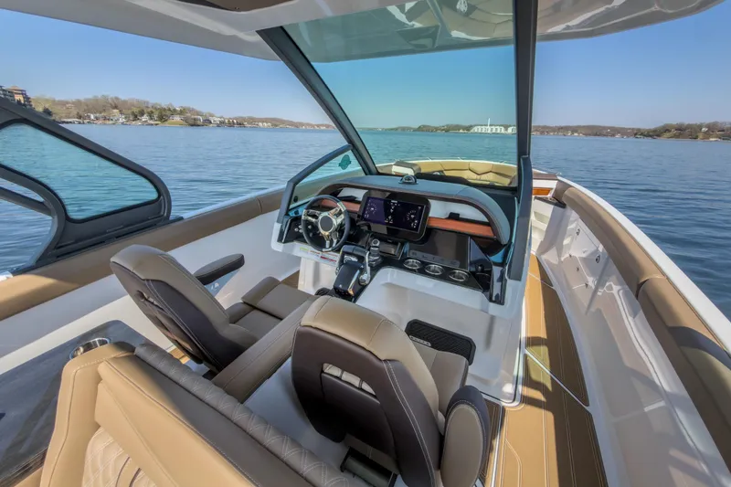 Slide: The Image of Interior view of 2026 Monterey Elite 30 OB boat with modern dashboard and seating. - 28