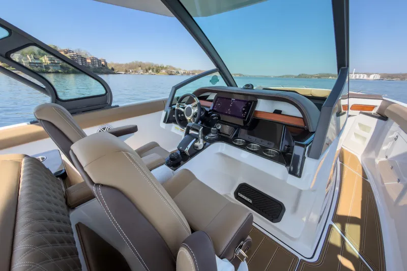 Slide: The Image of Luxurious interior of 2026 Monterey Elite 30 OB boat with modern dashboard and seating. - 29