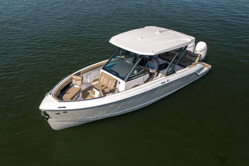 Slide: The Image of 2026 Monterey Elite 30 OB boat on calm water, featuring sleek design and spacious seating. - 4