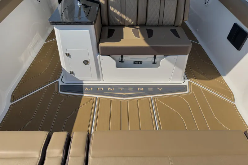 Slide: The Image of 2026 Monterey Elite 30 OB boat interior with cushioned seating and sleek flooring design. - 40