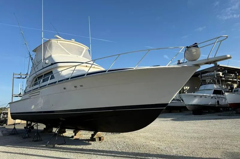 Slide: The Image of 1996 Bertram 50 Convertible yacht on dry dock under clear blue sky. - 11
