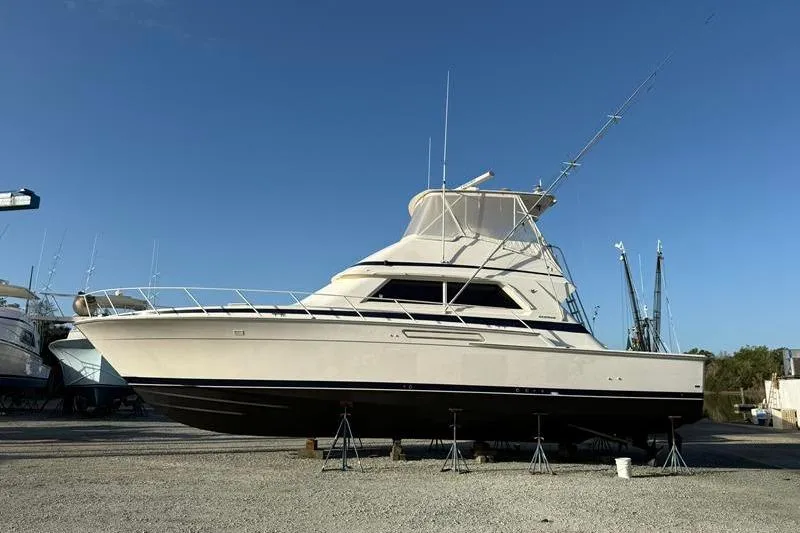 Slide: The Image of 1996 Bertram 50 Convertible yacht on dry dock under clear blue sky. - 14