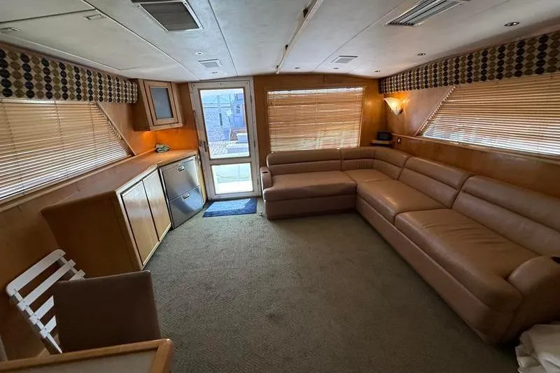 Slide: The Image of Spacious interior of a 1996 Bertram 50 Convertible yacht with leather seating. - 16