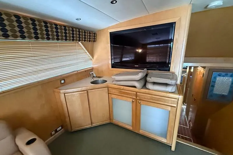 Slide: The Image of Interior of a 1996 Bertram 50 Convertible yacht with TV and sink. - 17