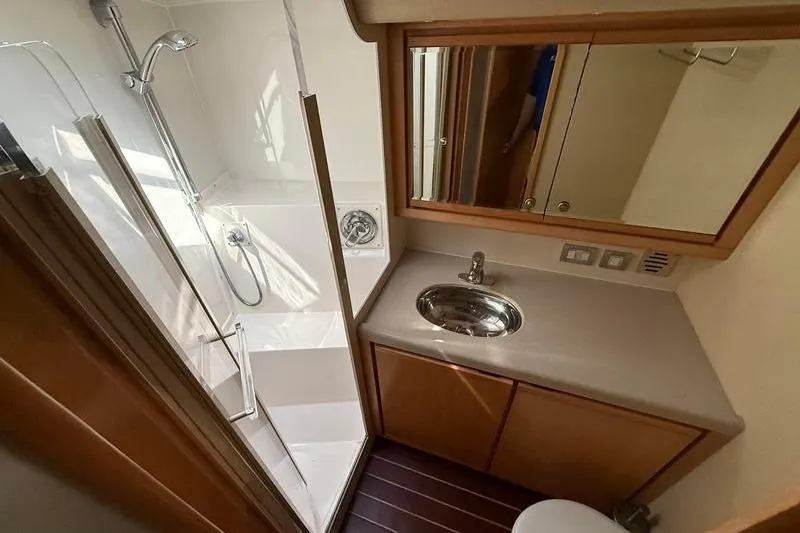 Slide: The Image of Bathroom interior of a 1996 Bertram 50 Convertible yacht with shower and sink. - 25