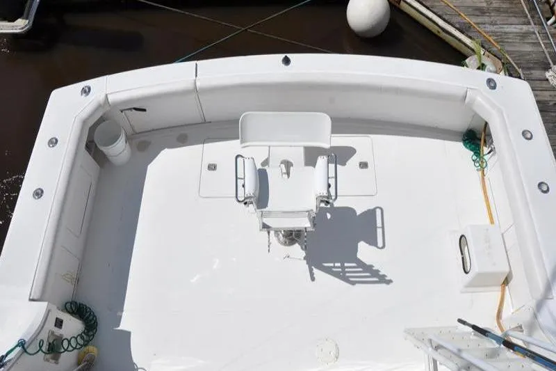 Slide: The Image of 1996 Bertram 50 Convertible boat deck with fishing chair and clean layout. - 28