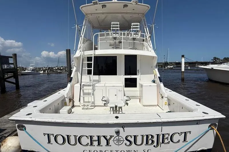 Slide: The Image of 1996 Bertram 50 Convertible yacht docked, named "Touchy Subject," in Georgetown, SC marina. - 3