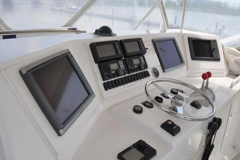 Slide: The Image of Cockpit of 1996 Bertram 50 Convertible yacht with navigation equipment and steering wheel. - 30