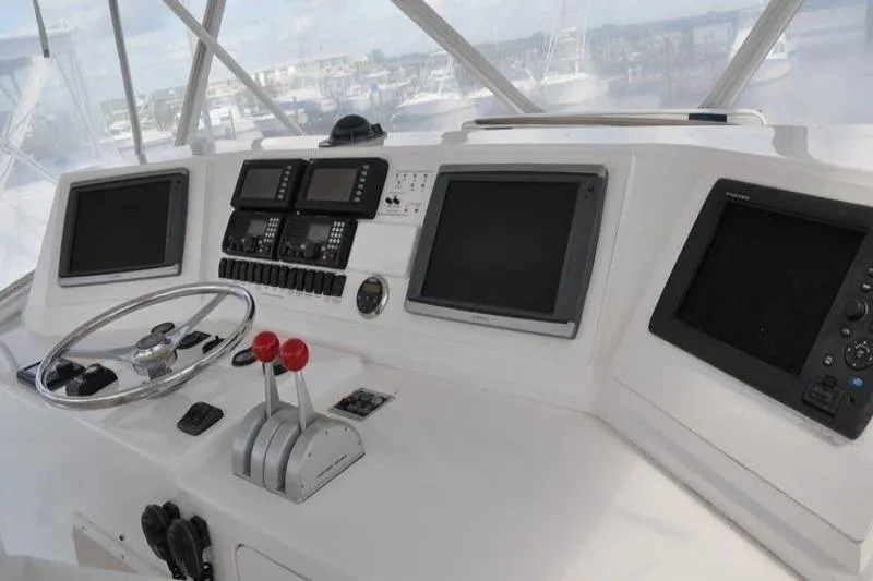 Slide: The Image of Helm of 1996 Bertram 50 Convertible yacht with navigation screens and controls. - 31