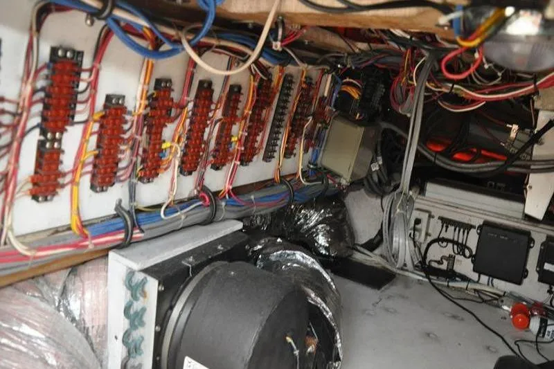 Slide: The Image of Electrical wiring and components inside a 1996 Bertram 50 Convertible boat. - 33
