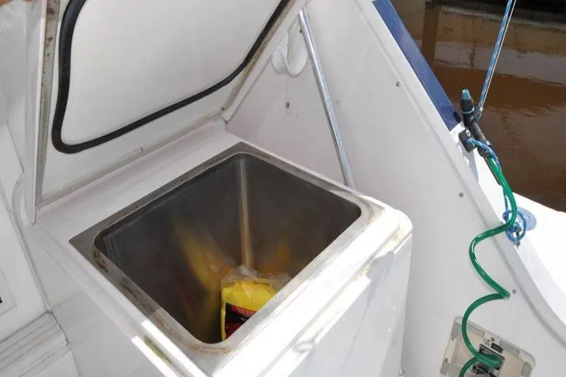Slide: The Image of Open storage compartment on a 1996 Bertram 50 Convertible boat deck. - 35