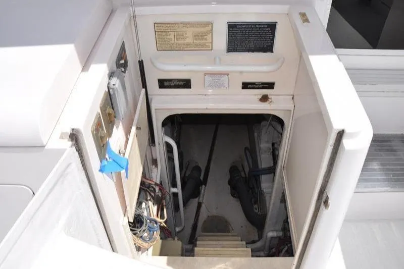 Slide: The Image of Engine room access on a 1996 Bertram 50 Convertible yacht, showing stairs and equipment. - 36