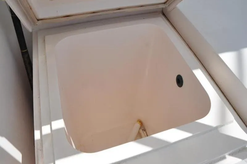 Slide: The Image of Open storage compartment on a 1996 Bertram 50 Convertible boat. - 38