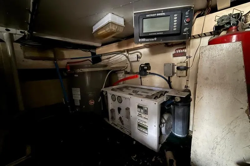 Slide: The Image of Engine room of a 1996 Bertram 50 Convertible yacht with control panel and equipment. - 44