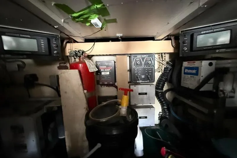 Slide: The Image of Engine room of a 1996 Bertram 50 Convertible with control panels and equipment. - 46