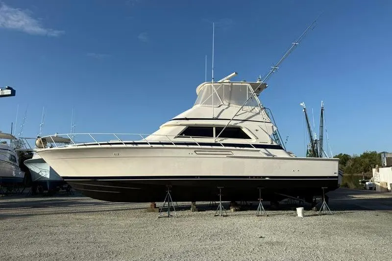 Slide: The Image of 1996 Bertram 50 Convertible yacht on stands under clear blue sky. - 5
