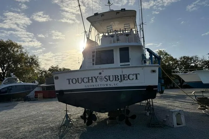 Slide: The Image of 1996 Bertram 50 Convertible boat named "Touchy Subject" in Georgetown, SC, at sunset. - 7