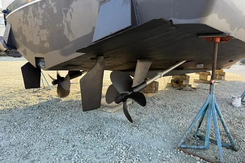 Slide: The Image of 1996 Bertram 50 Convertible boat propellers and rudders on dry dock. - 9