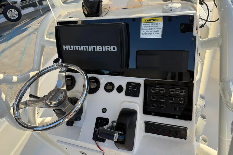 Slide: The Image of 2019 Skeeter SX240 boat dashboard with Humminbird electronics and steering wheel. - 12