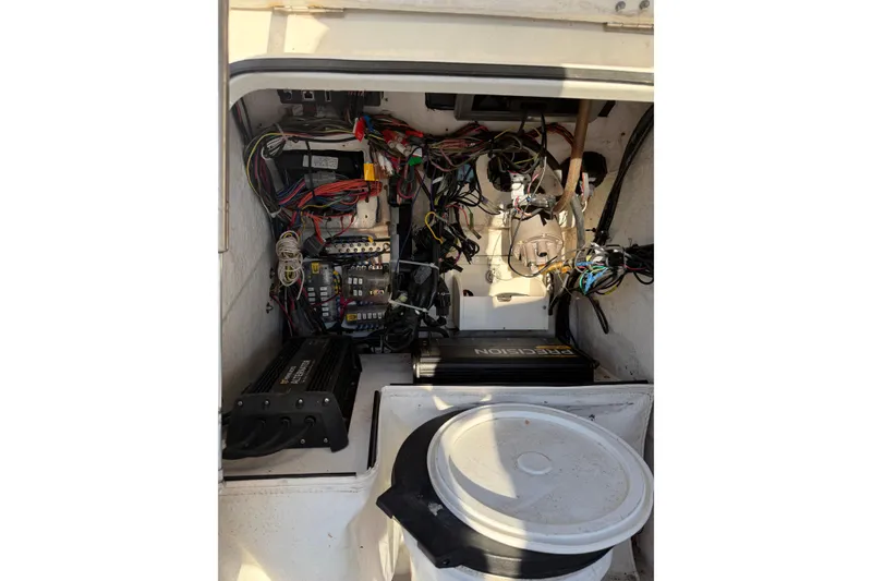 Slide: The Image of 2019 Skeeter SX240 boat wiring and electrical components in storage compartment. - 13