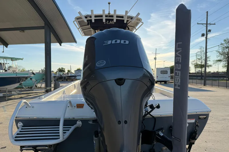 Slide: The Image of 2019 Skeeter SX240 boat with a 300 HP engine, parked outdoors. - 7