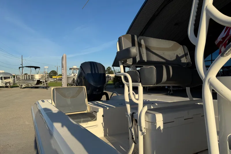Slide: The Image of 2019 Skeeter SX240 boat with seating and motor, parked outdoors under clear sky. - 9