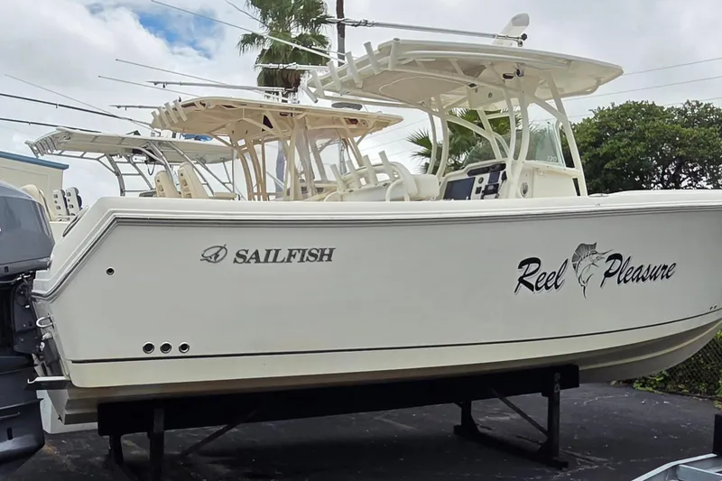 The Image of 2016 Sailfish 320 CC boat named "Reel Pleasure" on display, featuring sleek design. - 0