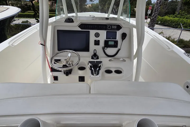 Slide: The Image of Cockpit view of 2016 Sailfish 320 CC boat with steering wheel and navigation equipment. - 14
