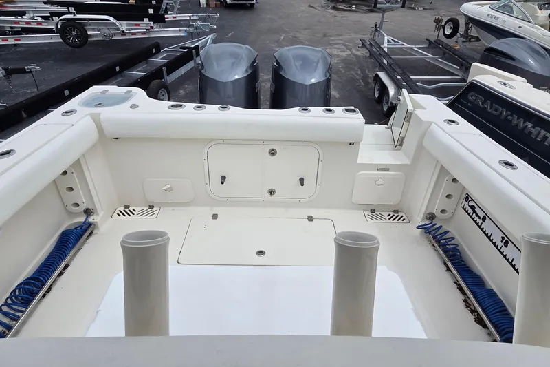 Slide: The Image of 2016 Sailfish 320 CC boat interior with storage compartments and fishing rod holders. - 17