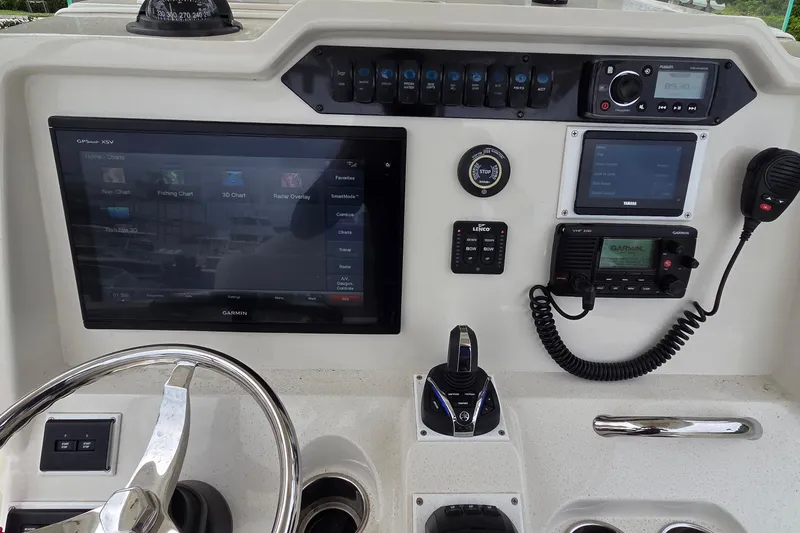 Slide: The Image of Control panel of a 2016 Sailfish 320 CC boat with Garmin navigation system. - 18
