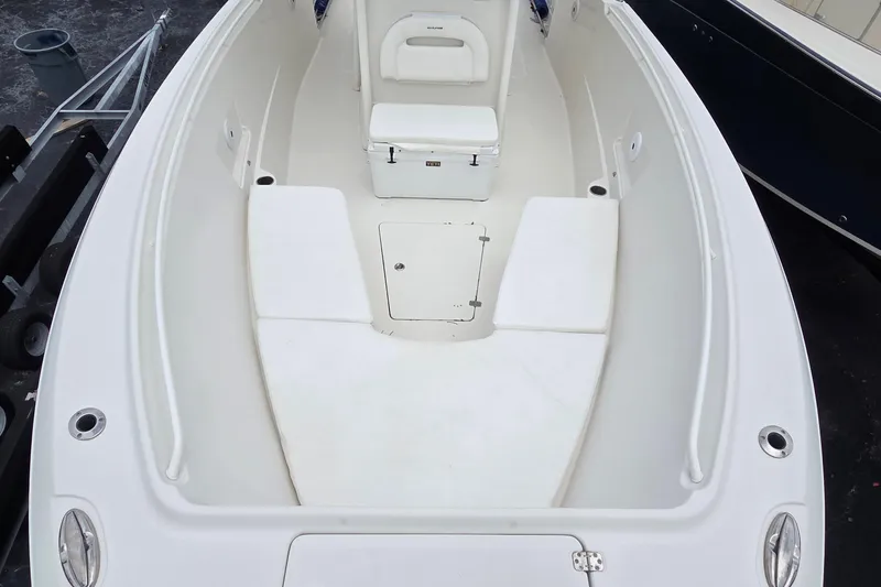Slide: The Image of 2016 Sailfish 320 CC boat interior with white seating and storage compartments. - 3