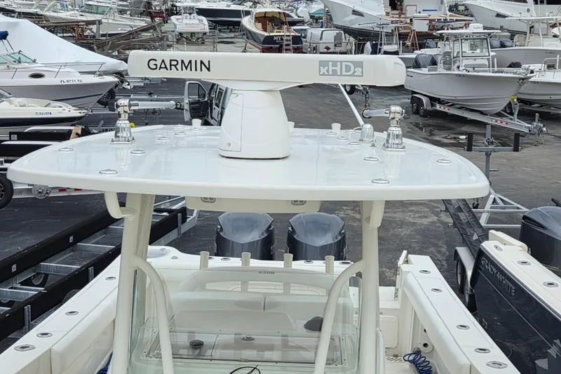 Slide: The Image of 2016 Sailfish 320 CC boat with Garmin xHD2 radar, docked among other boats. - 5