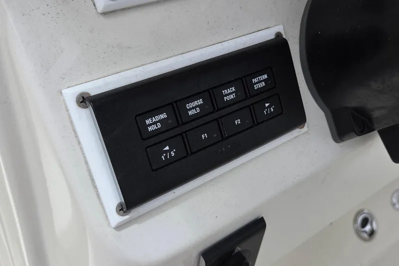 Slide: The Image of Control panel on a 2016 Sailfish 320 CC boat dashboard with navigation buttons. - 9