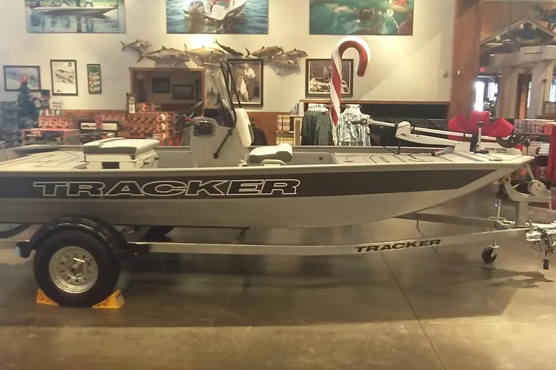 Slide: The Image of 2026 Tracker Bass Tracker Classic CC boat displayed indoors with fishing gear. - 2