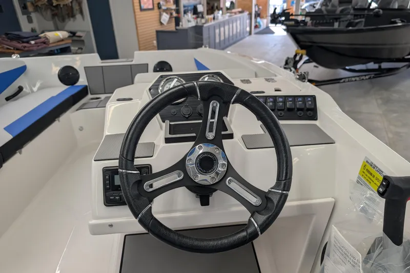 Slide: The Image of 2025 Starcraft SV 16 OB boat dashboard with steering wheel and control panel. - 13