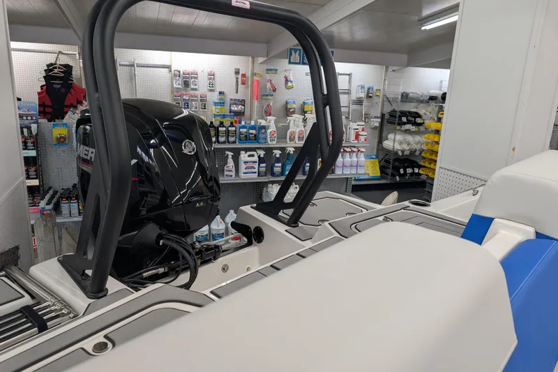 Slide: The Image of 2025 Starcraft SV 16 OB boat with outboard motor in a marine supply store. - 14
