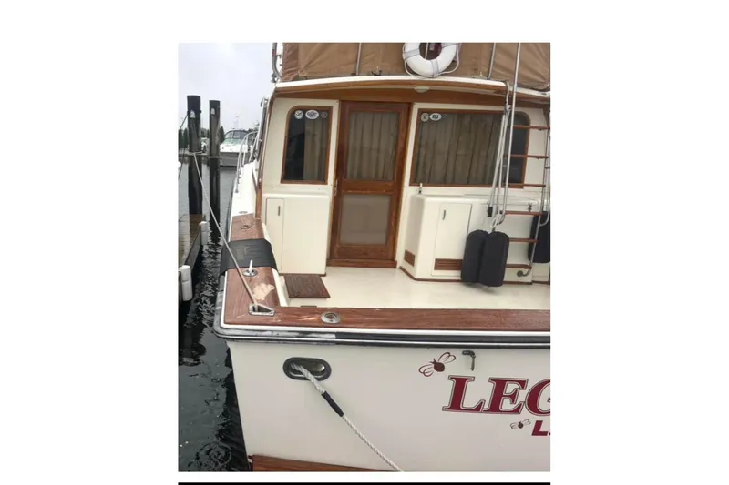 Slide: The Image of 1988 Egg Harbor 35 Sport Fisherman docked, featuring wooden accents and nautical equipment. - 2