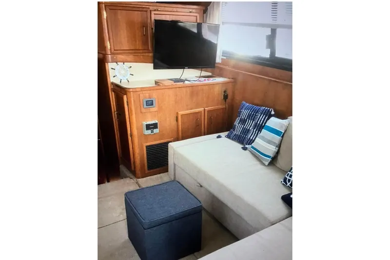 Slide: The Image of Interior of 1988 Egg Harbor 35 Sport Fisherman with cozy seating and modern TV setup. - 3