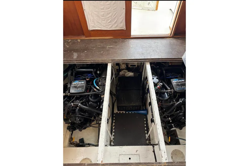 Slide: The Image of Engine compartment of a 1988 Egg Harbor 35 Sport Fisherman boat, featuring twin MerCruiser 7.4L engines. - 4