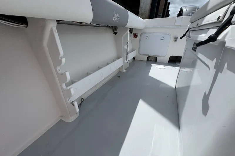 Slide: The Image of 2019 Steiger Craft 255 Miami boat interior with rod holders and storage compartments. - 12