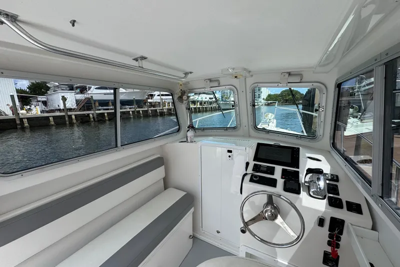 Slide: The Image of Interior of 2019 Steiger Craft 255 Miami boat with helm and seating area. - 14