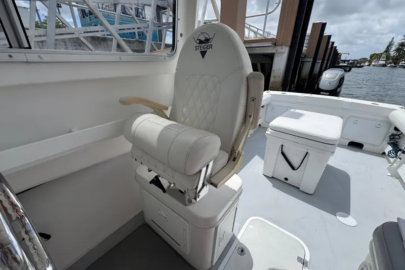 Slide: The Image of 2019 Steiger Craft 255 Miami boat interior with captain's chair and deck view. - 16