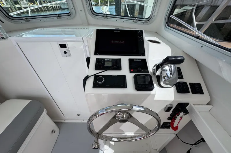 Slide: The Image of Helm of 2019 Steiger Craft 255 Miami with navigation controls and steering wheel. - 17