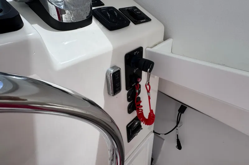 Slide: The Image of Control panel of a 2019 Steiger Craft 255 Miami boat with safety lanyard. - 18