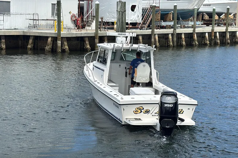 Slide: The Image of 2019 Steiger Craft 255 Miami boat with Suzuki 350 engine near dock. - 2